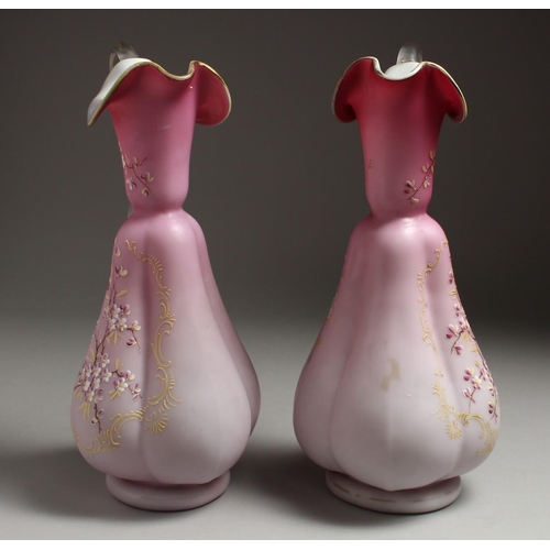 1086 - A PAIR OF SATIN GLASS JUGS painted with flowers. 12ins high.