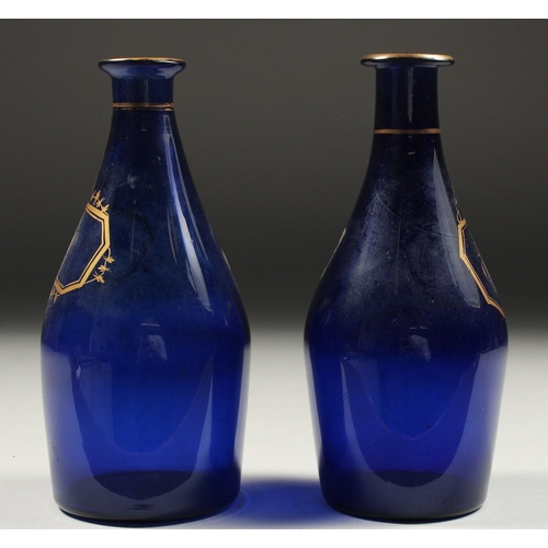 1089 - TWO BRISTOL BLUE DECANTERS 'RUM' and 'BRANDY'. 7ins high (one A/F).