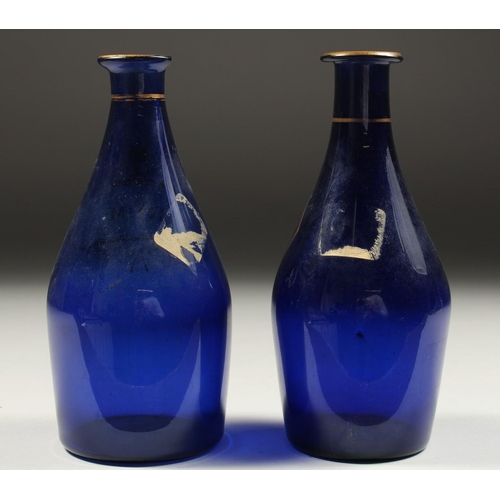 1089 - TWO BRISTOL BLUE DECANTERS 'RUM' and 'BRANDY'. 7ins high (one A/F).