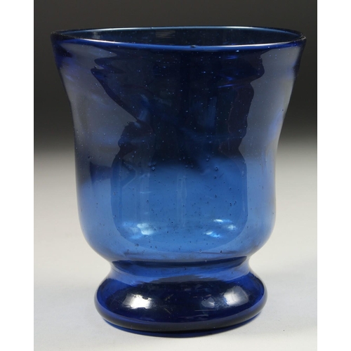 1090 - AN OLD BLUE GLASS VASE. 5.5ins high.