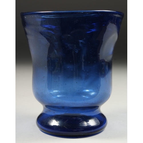 1090 - AN OLD BLUE GLASS VASE. 5.5ins high.