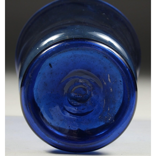 1090 - AN OLD BLUE GLASS VASE. 5.5ins high.