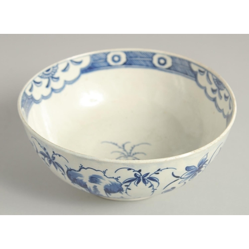 1111 - AN 18TH CENTURY WORCESTER BOWL painted with the uncommon Late Rock Floral pattern, crescent mark.