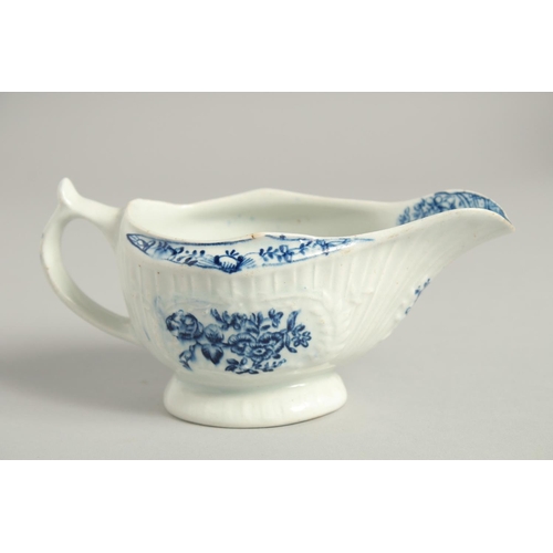 1138 - AN 18TH CENTURY LOWESTOFT FINE SMALL SAUCE BOAT with a pleat moulded body and moulded cartouches pri... 