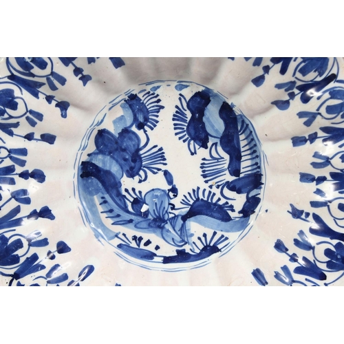 1153 - A 19TH CENTURY BLUE AND WHITE DEEP CHARGER with Chinese design. 10ins diameter.