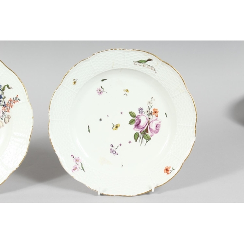 1161 - A GOOD PAIR OF MEISSEN CIRCULAR PLATES sprigged and painted with flowers. Cross swords mark in blue.... 