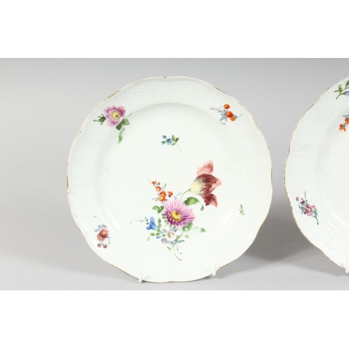 1162 - A SET OF THREE MEISSEN CIRCULAR PLATES sprigged and painted with flowers. Cross swords mark in blue.... 