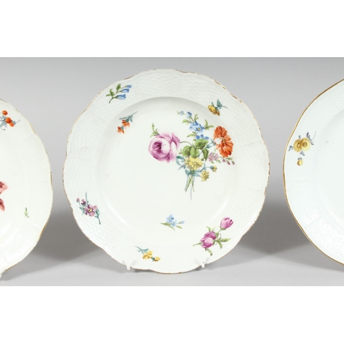 1162 - A SET OF THREE MEISSEN CIRCULAR PLATES sprigged and painted with flowers. Cross swords mark in blue.... 