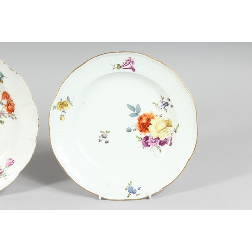 1162 - A SET OF THREE MEISSEN CIRCULAR PLATES sprigged and painted with flowers. Cross swords mark in blue.... 