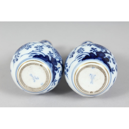 1167 - A SMALL PAIR OF MEISSEN ONION PATTERN BOTTLE VASES. Cross swords mark in blue, 4.5ins high.