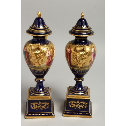 1170 - A SUPERB PAIR OF 19TH CENTURY VIENNA URNS VASES, COVERS AND STANDS, rich blue ground decorated in gi... 