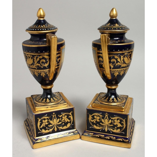 1171 - A SUPERB SMALL PAIR OF VIENNA URNS, COVERS AND STANDS rich gilt decoration and painted classical sce... 