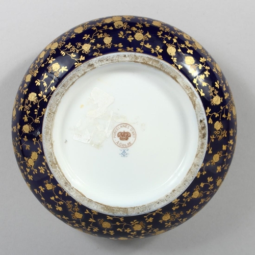 1172 - A GOOD 19TH CENTURY SHAPED PORCELAIN CIRCULAR BOX AND COVER, blue and gilt ground, the lid painted w... 