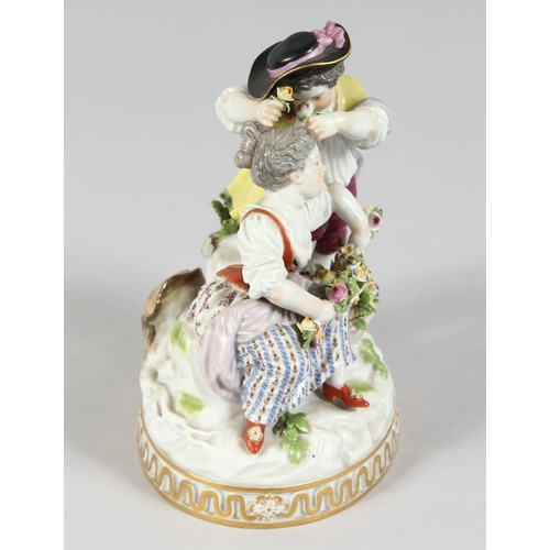 1175 - A GOOD MEISSEN PORCELAIN GROUP OF A BOY AND GIRL with garlands of flowers on an oval base. Cross swo... 