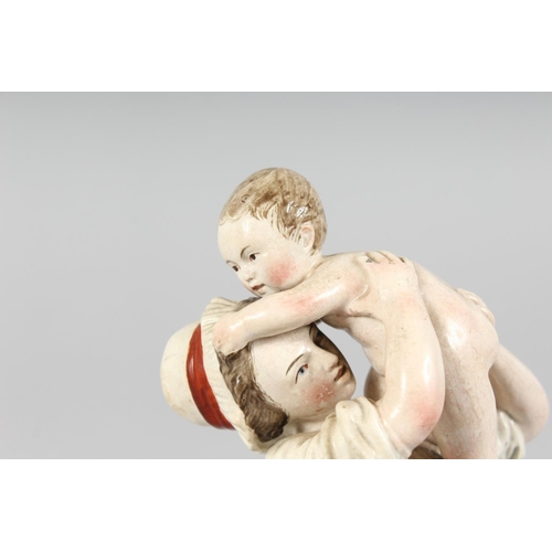 1176 - A GOOD HOSCH FIGURE of a woman holding a baby. Wheel mark, No. 157/ 8.5ins high.