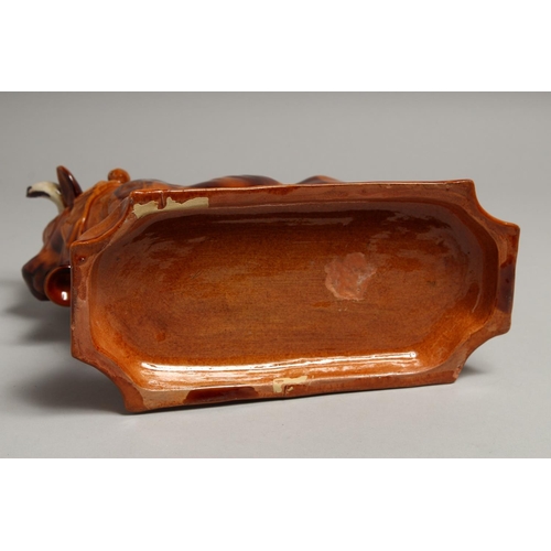 1177 - A PORTUGUESE POTTERY BULL on a rectangular base. 10ins long.