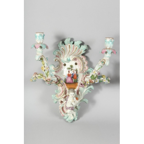 1189 - A GOOD PAIR OF MEISSEN PORCELAIN TWO BRANCH WALL SCONCES enamelled with flowers and cupids. Cross sw... 