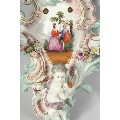 1189 - A GOOD PAIR OF MEISSEN PORCELAIN TWO BRANCH WALL SCONCES enamelled with flowers and cupids. Cross sw... 