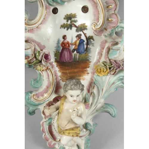 1189 - A GOOD PAIR OF MEISSEN PORCELAIN TWO BRANCH WALL SCONCES enamelled with flowers and cupids. Cross sw... 