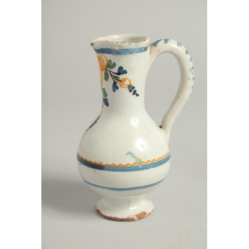 1207 - AN 18TH CENTURY TIN GLAZE CRUET with two jugs and a carrying handle. 4.5ins high.