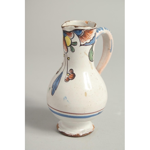 1207 - AN 18TH CENTURY TIN GLAZE CRUET with two jugs and a carrying handle. 4.5ins high.