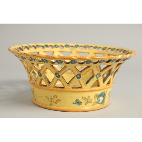 1211 - A CONTINENTAL YELLOW GROUP PIERCED CIRCULAR BASKET painted with flowers. 8ins diameter.