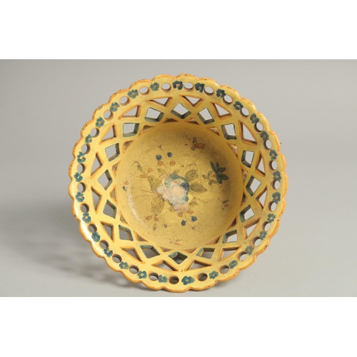 1211 - A CONTINENTAL YELLOW GROUP PIERCED CIRCULAR BASKET painted with flowers. 8ins diameter.