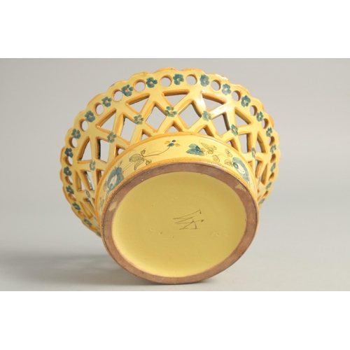 1211 - A CONTINENTAL YELLOW GROUP PIERCED CIRCULAR BASKET painted with flowers. 8ins diameter.