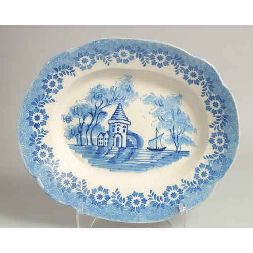 1214 - A BLUE AND WHITE OVAL METAL PLATE with a building and a ship. 14ins long.