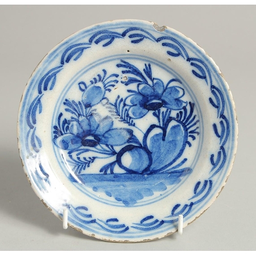 1217 - A SMALL 19TH CENTURY DELFT BLUE AND WHITE PLATE. 6.5ins diameter.