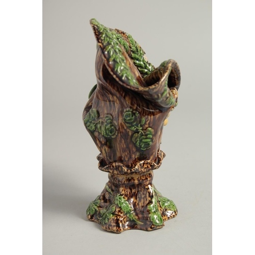 1219 - A SMALL MAJOLICA BROWN GLAZE VASE. 6ins high.