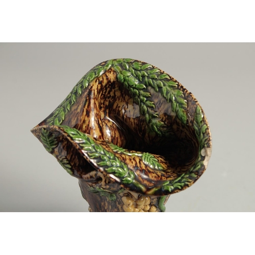 1219 - A SMALL MAJOLICA BROWN GLAZE VASE. 6ins high.