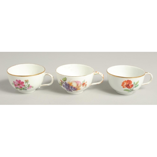 1220 - THREE 19TH CENTURY BERLIN PORCELAIN CUPS painted with flowers. Sceptre mark in blue.