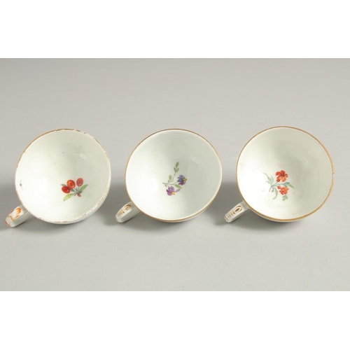 1220 - THREE 19TH CENTURY BERLIN PORCELAIN CUPS painted with flowers. Sceptre mark in blue.