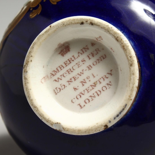 1224 - CHAMBERLAIN & CO. WORCESTER, a small porcelain bottle vase, rich blue ground painted with a panel of... 