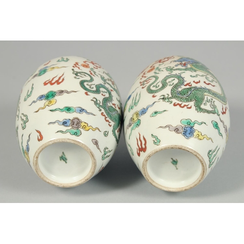 1247 - A PAIR OF CHINESE VASES decorated with dragons. 8.5ins high.