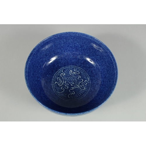 1250 - A CHINESE BLUE BOWL the sides with white dragons. 10ins diameter.