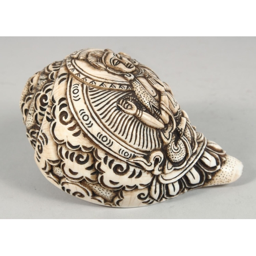 1253 - A LARGE CARVED CONCH SHELL WITH HINDU GOD. 16cm long.