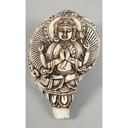 1253 - A LARGE CARVED CONCH SHELL WITH HINDU GOD. 16cm long.