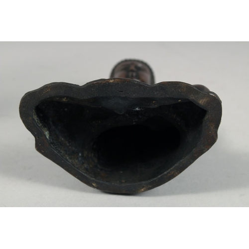 1254 - A BRONZE FIGURE OF SEATED BUDDHA, rested on a detachable base.  22cm high overall.