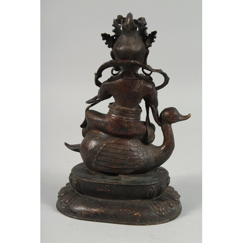 1255 - A LARGE BRONZE FIGURE OF A SEATED DEITY, sat upon a bird and on a lotus base, with traces of gilt, 2... 