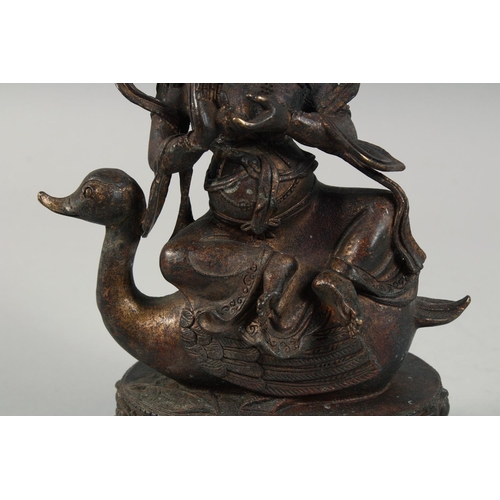 1255 - A LARGE BRONZE FIGURE OF A SEATED DEITY, sat upon a bird and on a lotus base, with traces of gilt, 2... 