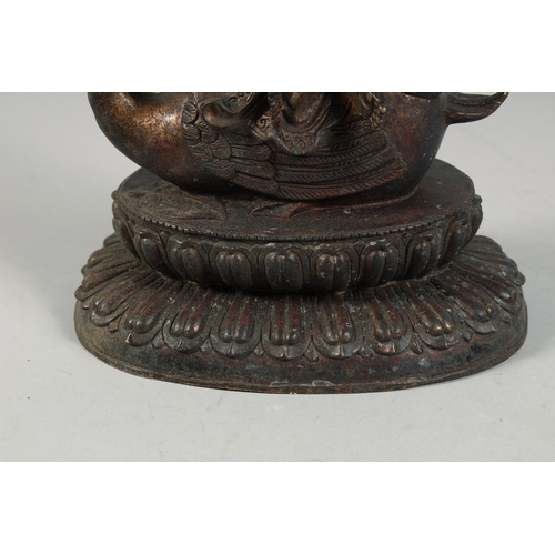 1255 - A LARGE BRONZE FIGURE OF A SEATED DEITY, sat upon a bird and on a lotus base, with traces of gilt, 2... 