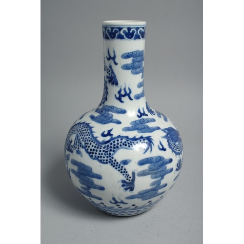 1260 - A CHINESE BLUE AND WHITE PORCELAIN BOTTLE VASE, painted with dragons and the flaming pearl of wisdom... 