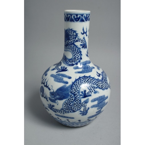 1260 - A CHINESE BLUE AND WHITE PORCELAIN BOTTLE VASE, painted with dragons and the flaming pearl of wisdom... 