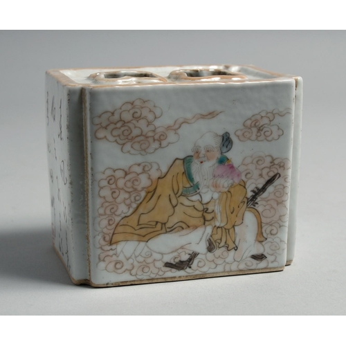 1264 - A CHINESE PORCELAIN INKWELL, painted with figures and script. 10cm wide.