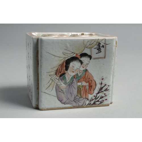 1264 - A CHINESE PORCELAIN INKWELL, painted with figures and script. 10cm wide.