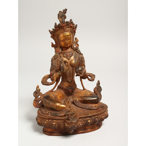 1267 - A CHINESE GILT BRONZE SEATED DEITY, with coral and turquoise. Signed. 9ins high.