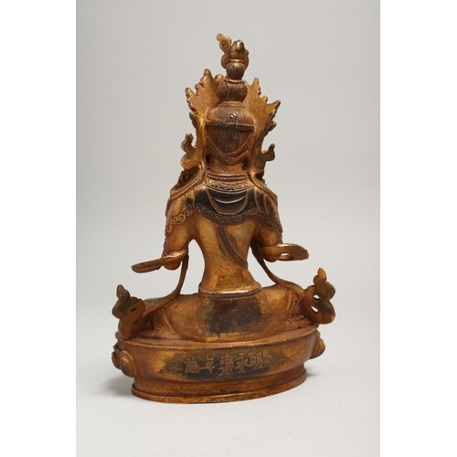 1267 - A CHINESE GILT BRONZE SEATED DEITY, with coral and turquoise. Signed. 9ins high.