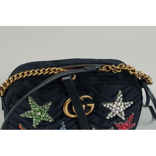 1546 - A GUCCI BLACK VELVET LTD. EDITION STAR BAG. 9.5ins x 5ins with a double 'G' and six coloured stars, ... 